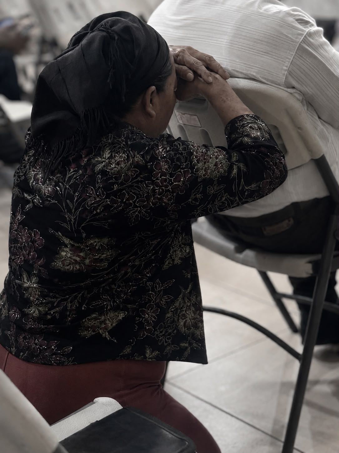 Mujer orando durante una reunión